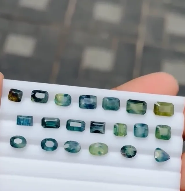 Parcel of teal sapphires on a white tray
