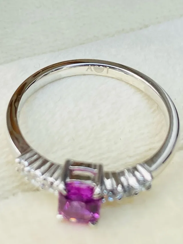 Ring set with a pink sapphire and side stones