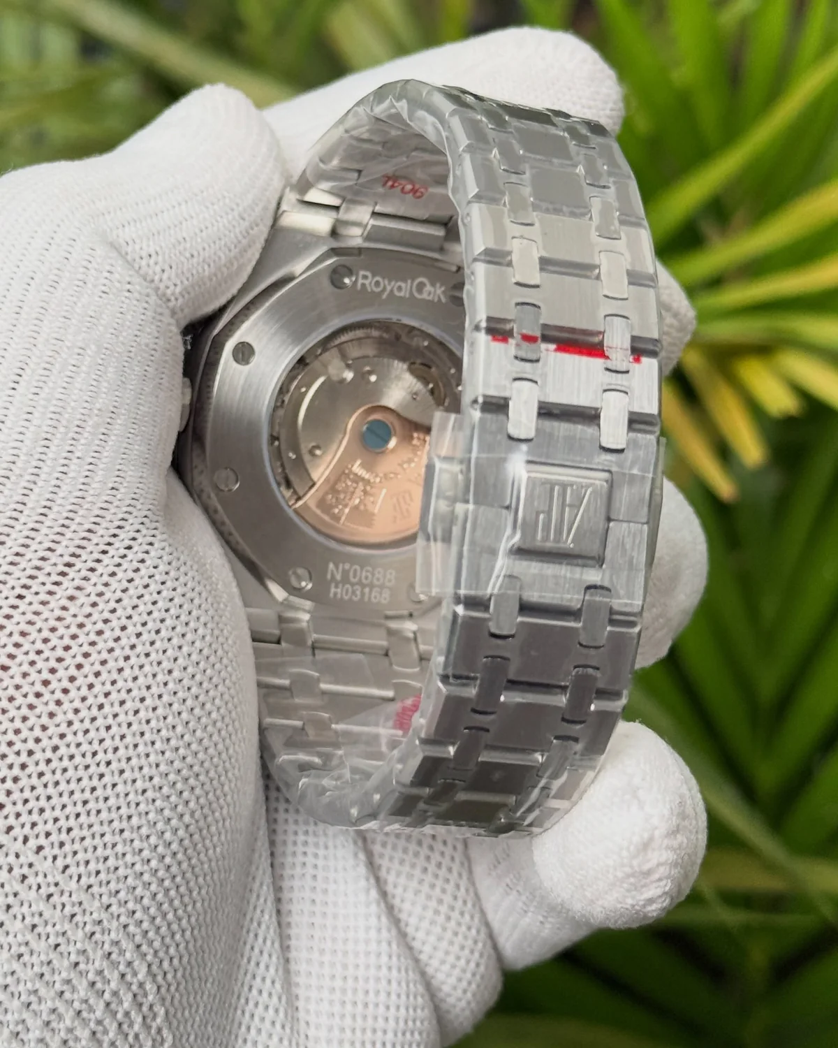 Back of the green-dial watch, showing an exhibition caseback